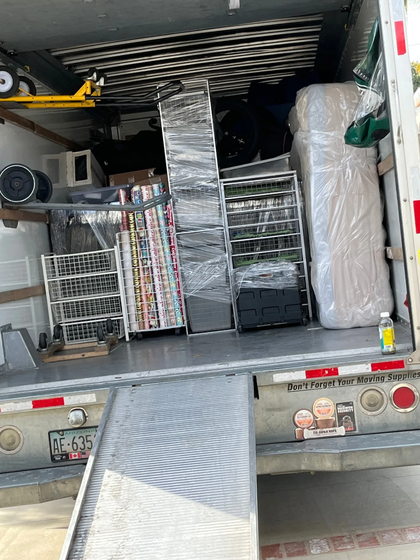 Inside a fully loaded Green Echo moving truck with furniture wrapped and stacked tightly