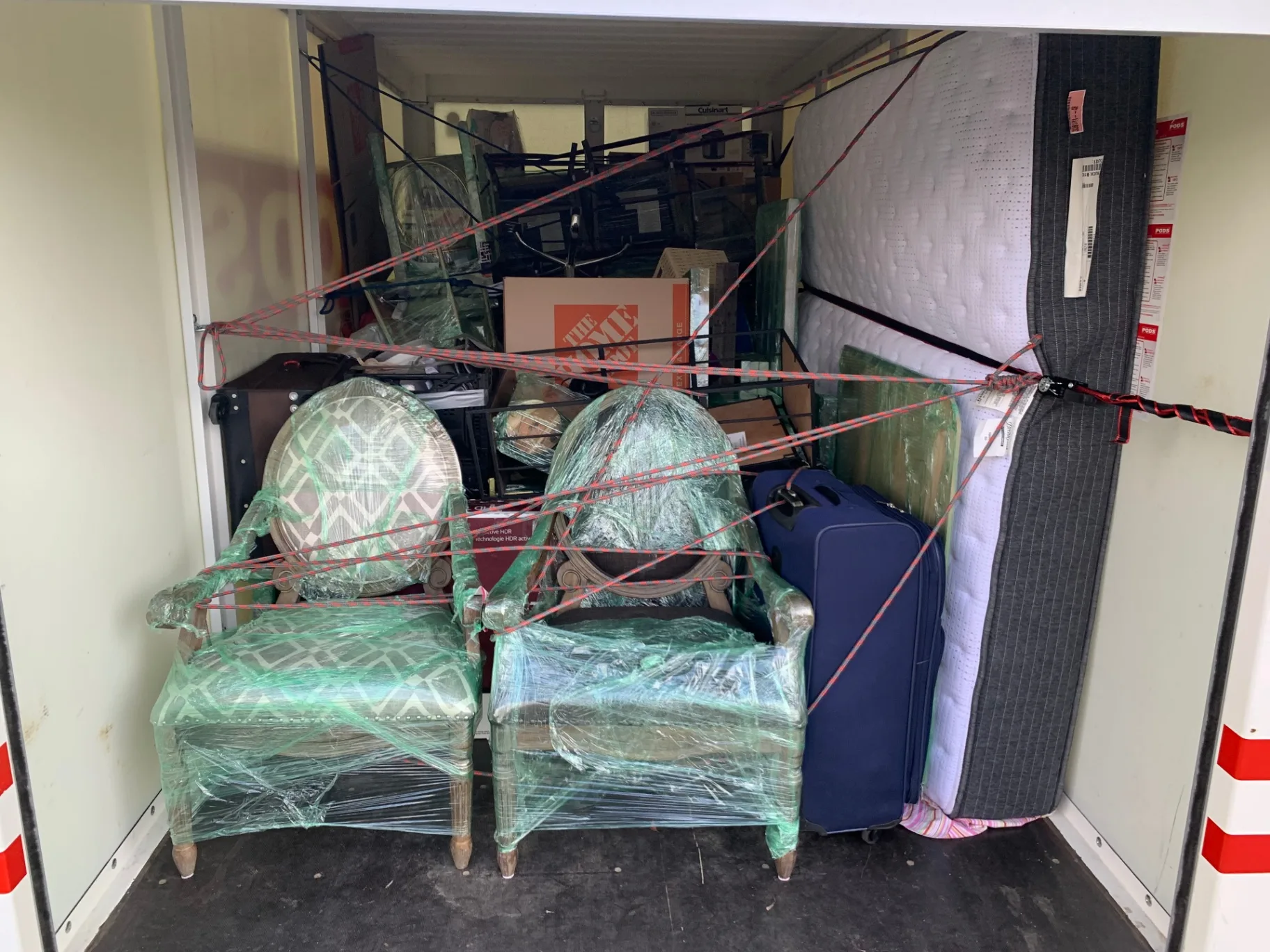 Furniture, mattresses and chairs strapped and secured inside a storage container